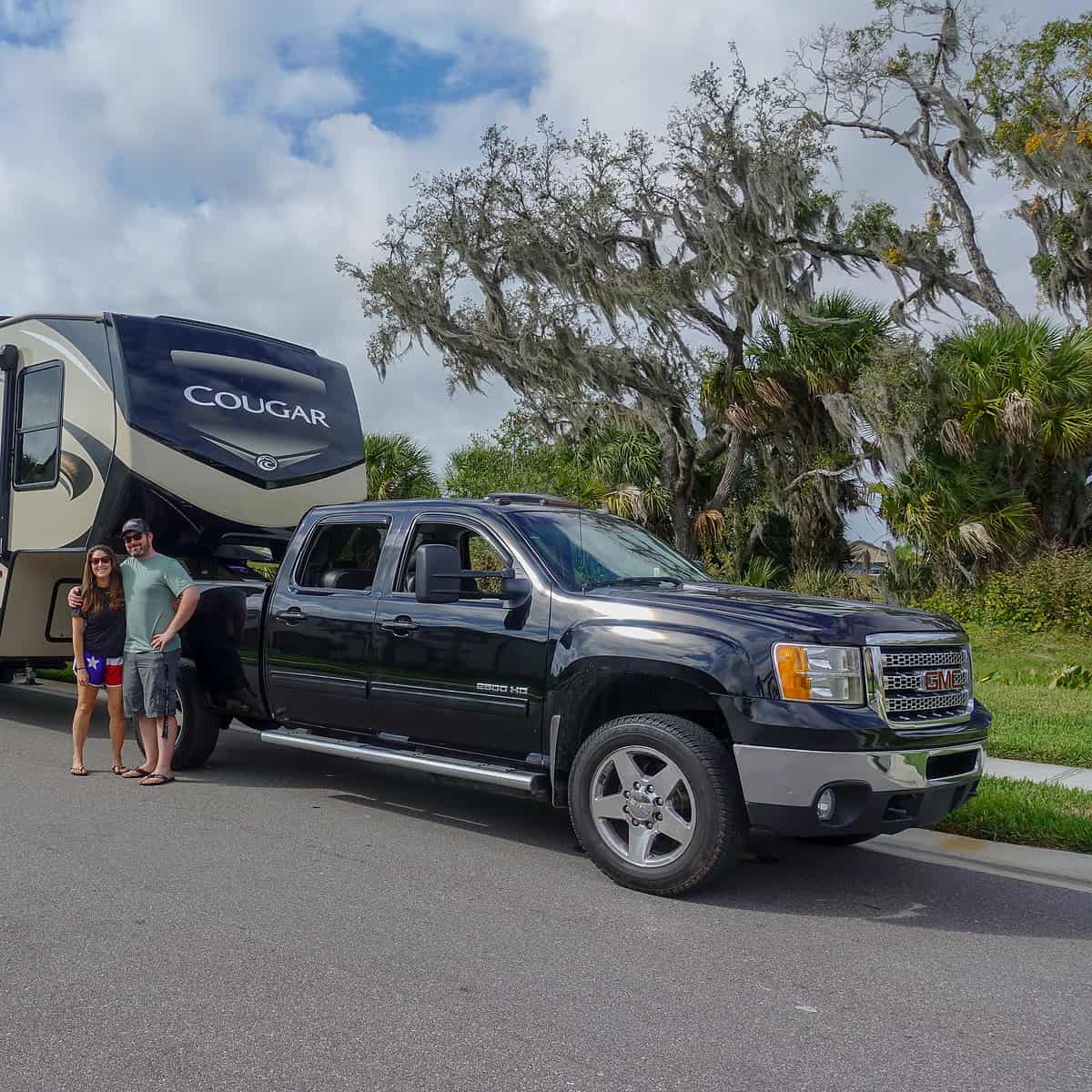 Full-Time RVers Cindy and Barrett standing in front of their RV