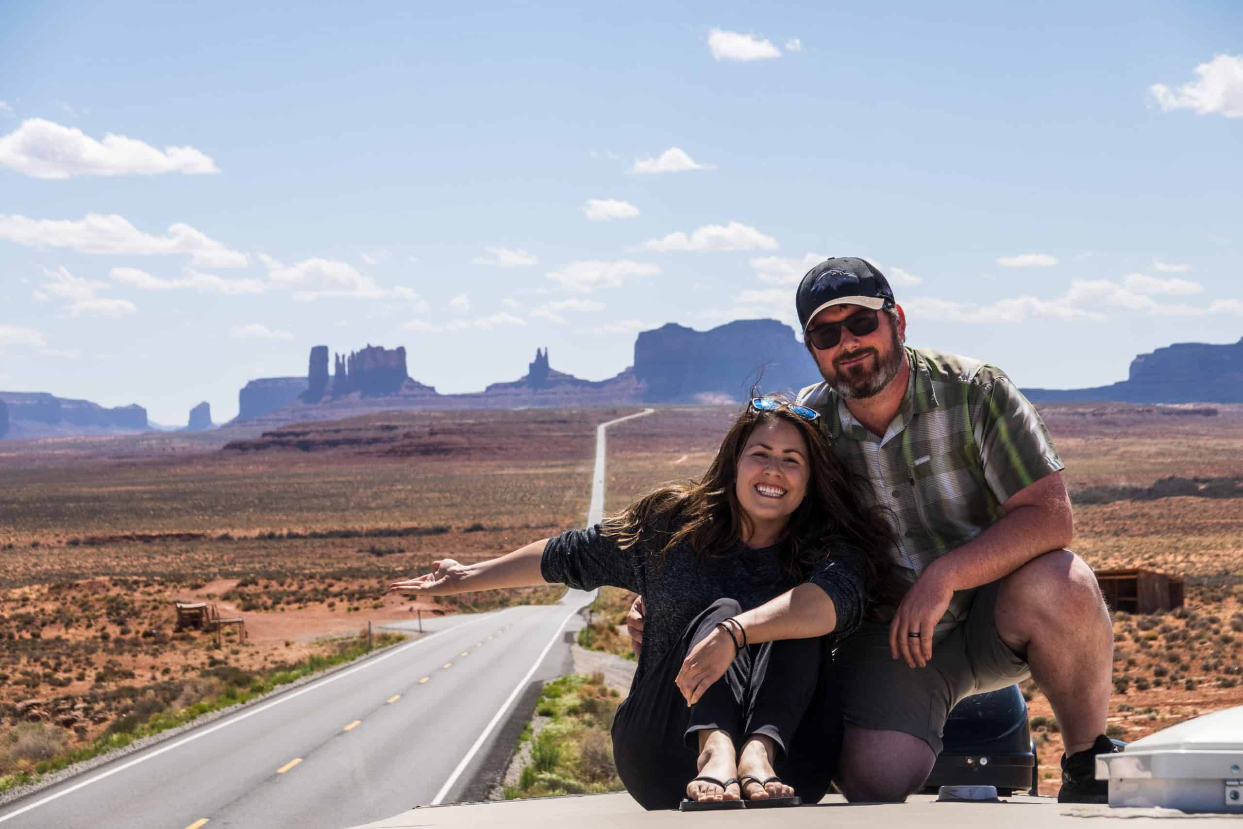 Cindy and Barrett taking a photo on the roof of their RV with their selfie stick