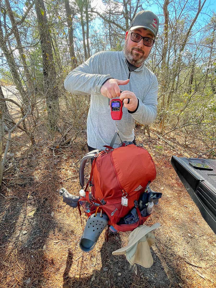 Barrett weighing his pack at the beginning of a test shakedown hike.