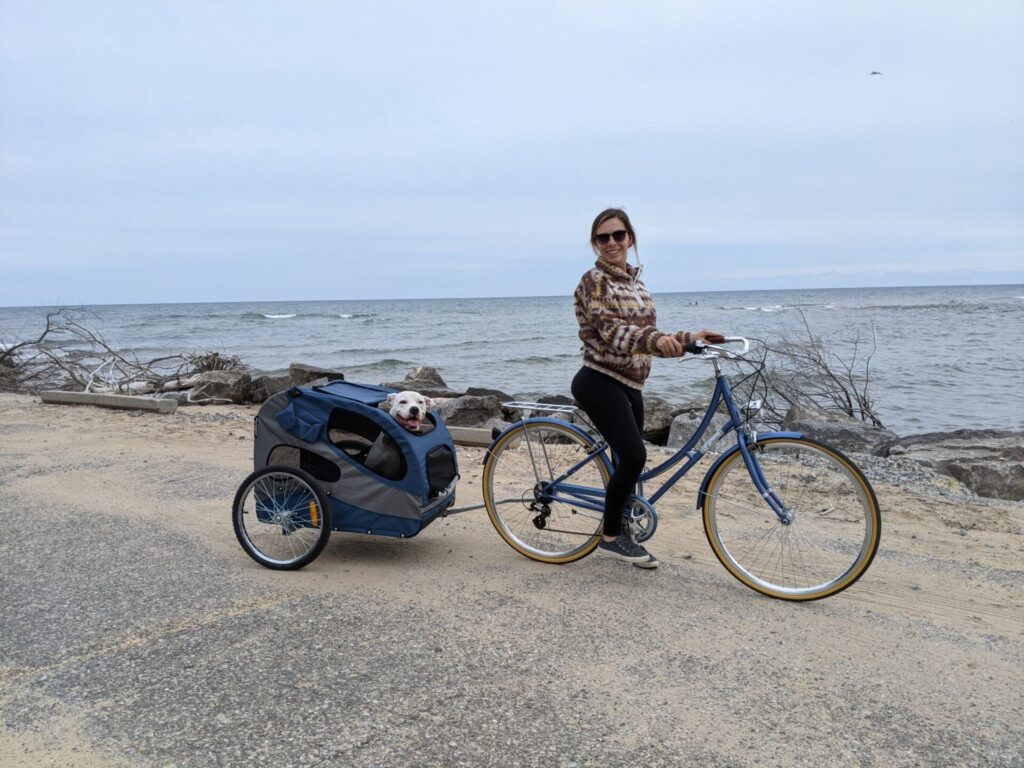 Katherine on a bike with her dog, saving money and embracing cheap RV living