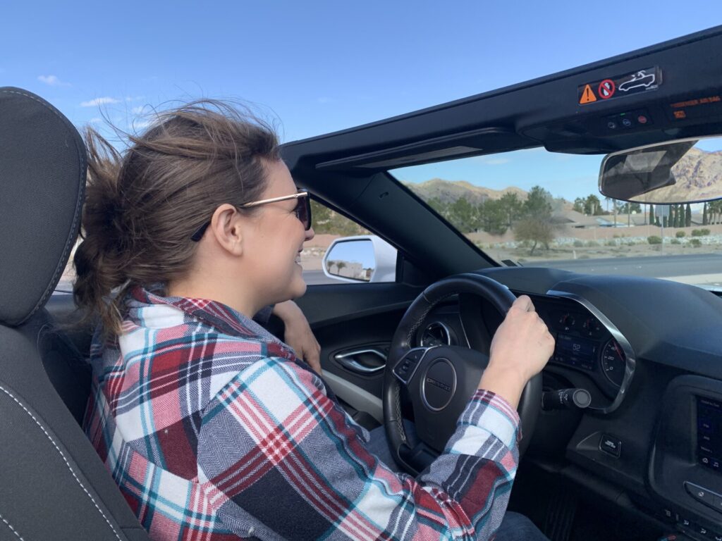 Cindy driving a convertible car