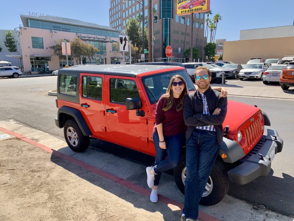 Cindy with Robb and his jeep, getting ready for a road trip